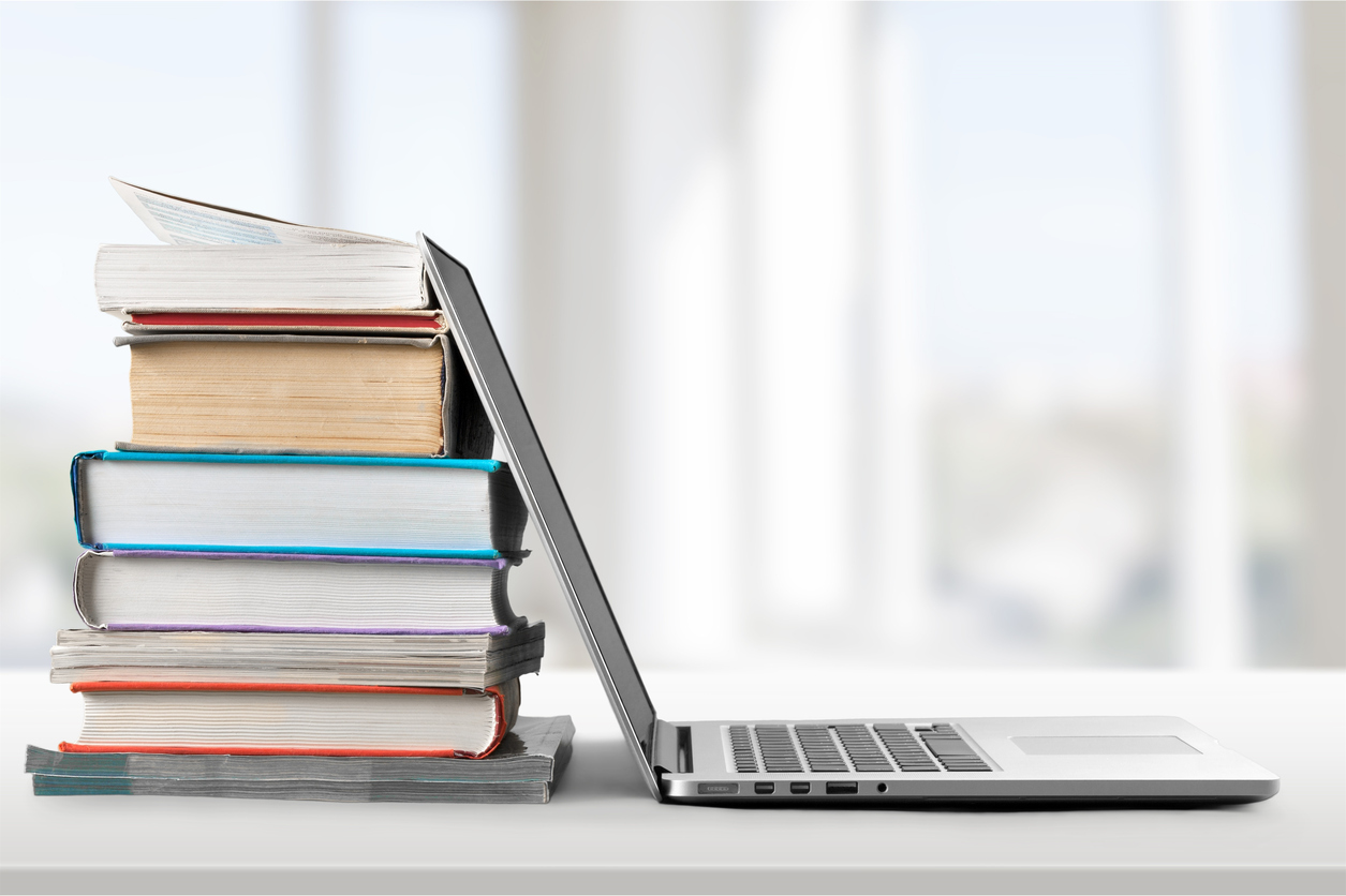 Laptop and study books on desk